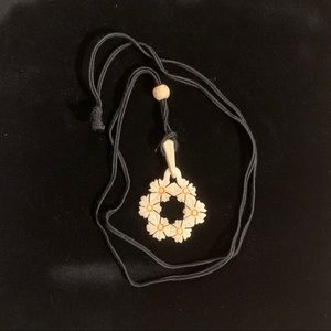 Carved daisy wreath pendant